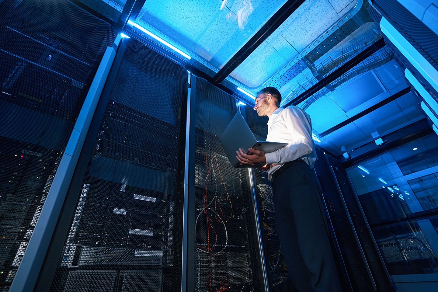 IT technician providing service in a network room.